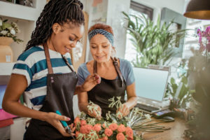 Flower Shop Workers Close up of a flower shop worker teaching the new employee