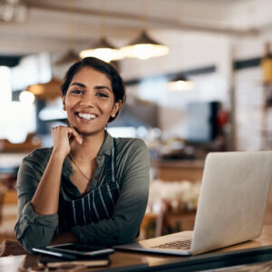 Nothing empowers you more than owning your own small business Shot of a young woman using a laptop while working in a cafe